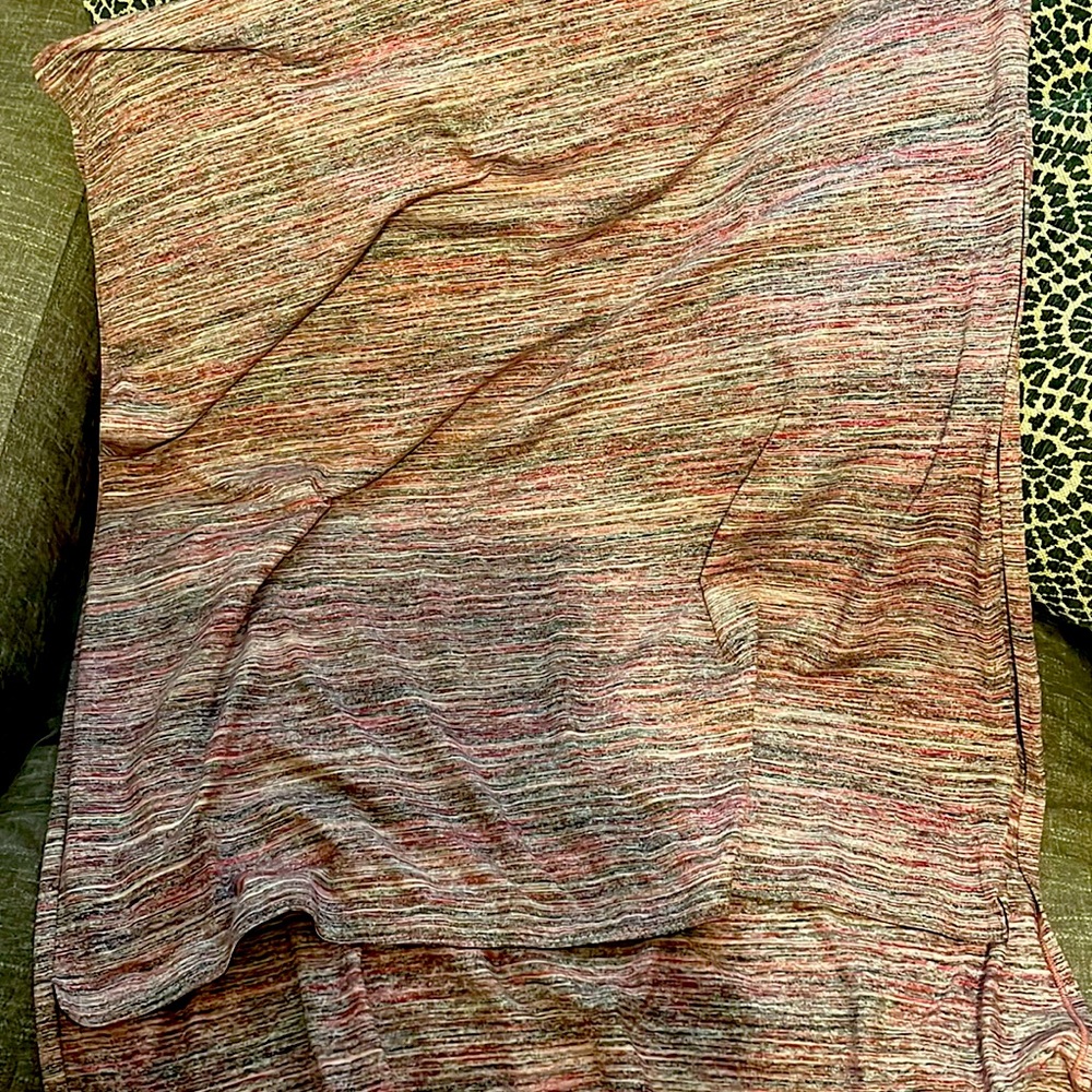 Lululemon scarf! I think it is the Vinyasa scarf with the snaps. Reddish color.